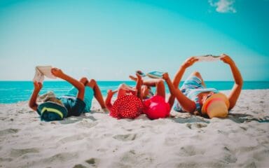 Family reading on a beach.