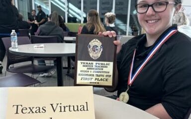 A child holding a plaque