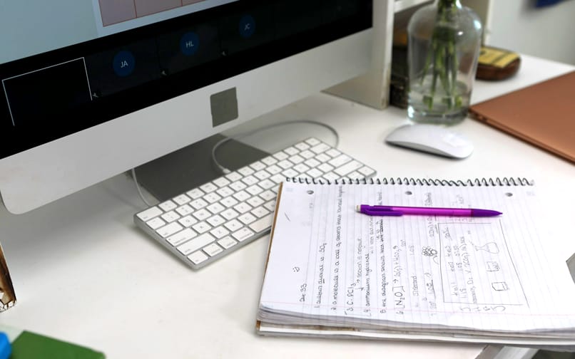 Keyboard, notebook and pencil